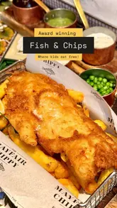 A family-focused vlog showcasing a visit to The Mayfair Chippy in Knightsbridge. The video highlights the 'Kids Eat Free' Easter promotion, features close-ups of their award-winning fish and chips, small plates, and cocktails, and captures the family-friendly atmosphere of the venue.