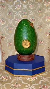 A short, polished unboxing video of a luxury handmade chocolate Easter egg from The Ritz London, featuring gold detailing and elegant packaging.