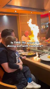 A promotional video for a teppanyaki restaurant highlighting its family-friendly 'Family Sundays' offering. The video features a chef performing cooking tricks with fire and food, while a toddler watches and engages with activity packs, demonstrating how the venue keeps children entertained during a meal.