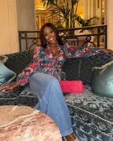 A portrait of a woman posing on a sofa within the opulent, classic interior of The Ritz London, capturing the venue's high-end atmosphere.