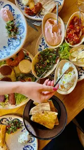 A video showcasing a visit to Ephesus Meze & Grill, featuring a variety of Turkish dishes including cold and hot meze platters, a mixed grill, and desserts.