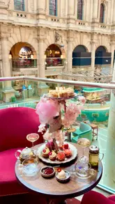 A beautifully filmed montage showcasing an afternoon tea service at a venue located within the Royal Exchange. The video highlights the intricate pastries, finger sandwiches, and tea service, set against the backdrop of the venue's grand architecture. The creator is shown enjoying the experience, emphasizing the elegant and peaceful atmosphere.