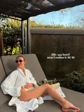 A high-quality, aspirational lifestyle shot featuring a creator relaxing on a sun lounger at a spa hotel. The composition is clean, well-lit, and effectively communicates a sense of luxury and relaxation, making it an appealing travel marketing image.