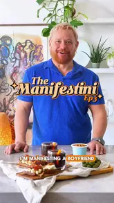 A creator demonstrates how to make a Negroni with espresso ice cubes and a side of gorgonzola, fig jam, and pancetta toast, framed within a humorous 'manifesting a boyfriend' narrative.