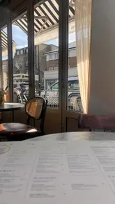 A vlog-style guide showcasing a budget-friendly day out in London, featuring a brunch spot called Brags & Brams, followed by a visit to Hackney City Farm and Haggerston Park.