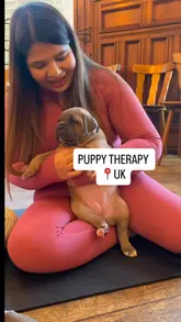 A vlog-style video featuring a creator and her mother attending a puppy therapy session followed by a meal at a pizzeria, highlighting both the activity and the food.