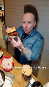 A couple documents their pre-flight meal at the Great Northern Market in Manchester Airport, highlighting burgers from Nashville Hot House, desserts from Gooey, and cocktails.