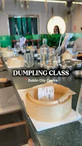 People at a hands-on dumpling making class at Lucky Tortoise in Dublin, with plates of fresh dumplings, drinks, and side dishes.