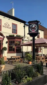 A promotional montage showcasing the newly refurbished The Old Horse pub, highlighting its interior decor, outdoor garden space, and menu items including scotch eggs, pizza, and cocktails.