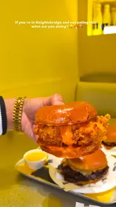 A fast-paced promotional video for G.O.A.T. Burger in Knightsbridge, featuring a montage of the restaurant's exterior, bright yellow interior, and a variety of their menu items including burgers, loaded fries, wings, and drinks.