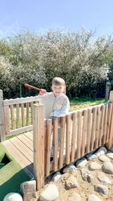 A montage of a family day out at Lee Valley Park Farms, showcasing various activities including an Easter egg hunt, playground, mini-golf, farm animals, and an Alice in Wonderland-themed show.