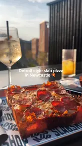 The video provides a concise tour of Slab Shop in Newcastle, focusing on their Detroit-style pizza and cocktail offerings. It features close-up shots of the food, the venue's interior and exterior, and the menu, creating an inviting atmosphere for a casual meal or drinks.