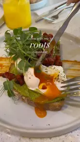 A short, energetic video showcasing a brunch visit to Roots in Upminster. The creators highlight the interior, the menu, and various dishes including avocado toast, pancakes, and a falafel bowl, while also mentioning the venue's evening events.