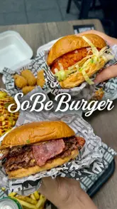 A short, punchy reel showcasing a variety of menu items from SoBe Burger in Luton, including burgers, loaded fries, wings, mac and cheese bites, and milkshakes. The video uses quick cuts and close-up shots to highlight the food's texture and presentation.