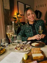 A high-quality, polished lifestyle shot featuring a creator at a restaurant, showcasing a 'chef's menu' experience. The image is well-composed, with flattering lighting and a professional aesthetic that conveys a warm, inviting atmosphere.