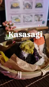 A short, energetic reel showcasing a Japanese Izakaya pop-up experience in Newcastle. The video features close-ups of various Japanese dishes like onigiri, yakitori, and miso-glazed aubergine, interspersed with shots of the creator and the menu.