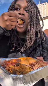 A review of a Black-owned Caribbean market stall in Bermondsey, featuring a variety of dishes including fish cakes, a fish cake burger, curry goat, and jerk chicken.