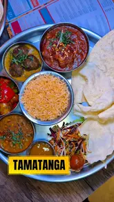 A promotional reel for Tamatanga in Leeds, featuring a montage of their unlimited thali, various curries, naan, and fries, interspersed with shots of the restaurant's colorful and vibrant interior design.