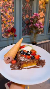 A review of Nest Cafe & Eatery in Chorlton, featuring a variety of dishes including a Mediterranean breakfast, French toast, and homemade focaccia sandwiches. The video highlights the cozy interior and the quality of the food.