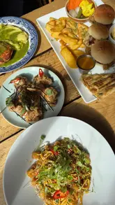 A couple visits a vegan pub in London, reviewing a wide selection of dishes including noodles, pie and mash, burgers, and desserts. The video features their genuine reactions to the food, highlighting the quality of the vegan menu to a non-vegan audience.