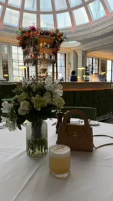 A short, aesthetic video showcasing a Sunday roast experience at a restaurant with a distinctive domed ceiling. The footage focuses on the interior architecture, the plating of the roast, a gravy pour, and the overall relaxed, upscale dining atmosphere.