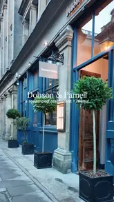 A visually appealing, high-quality montage showcasing the revamped interior, bar area, open kitchen, and various dishes and drinks at Dobson & Parnell. The video uses smooth, cinematic shots to create an inviting atmosphere.