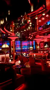 A cinematic showcase of Bund London, a hidden, upscale bar featuring moody red lighting, plush seating, and panoramic views of the London skyline. The video focuses on the atmosphere, interior design, and the experience of enjoying cocktails in a sophisticated setting.