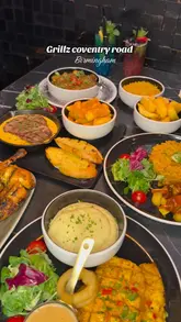 **Delicious grilled steak, fries, and dessert beautifully plated on a table at Grillz Steaks and Desserts restaurant in Birmingham.**