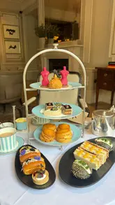 A visually focused reel showcasing a fashion-themed afternoon tea service at The Kensington Hotel. The video features close-up, high-quality shots of the tiered stand, including savoury tarts, brioche, and a signature chocolate bust dessert, set against a refined hotel interior.