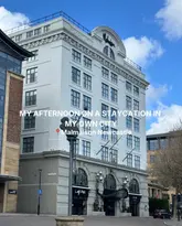 A static, eye-level architectural shot of the Malmaison Newcastle hotel exterior during the day. The image serves as an introduction to a staycation content piece, clearly identifying the venue with text overlay.