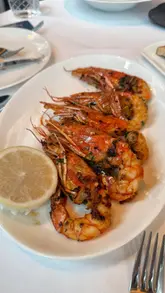 A high-quality, polished showcase of Sali e Pepe at The Langham, featuring elegant interiors, a wine cellar, and a selection of Italian dishes including prawns, tableside cacio e pepe, and tiramisu.