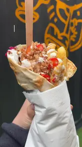 A short review video showcasing a Berlin-style kebab shop in Belfast, featuring close-up shots of the food preparation and the creator tasting the final product.