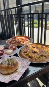A creator visits Pizza Punks for a birthday lunch, showcasing the interior, the new menu, and several pizza and side dishes, including the 'Nduja Mac Daddy and Hardcore Carnivore pizzas, and a loaded garlic bomb.