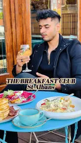 A vibrant brunch review featuring a variety of dishes including pancakes, a full American breakfast, avocado toast, French toast, and chicken and waffles. The video captures the creator's experience at The Breakfast Club in St Albans, highlighting the aesthetic presentation of the food and the inviting atmosphere of the venue.