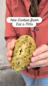 A promotional video for Eat a Pitta showcasing their new cookie range, falafel bowls, and waffle fries. The video features quick cuts of the ordering kiosk, the food counter, and close-ups of the food being prepared and eaten.