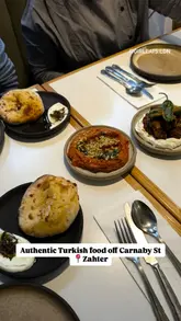 A short, fast-paced montage showcasing a variety of authentic Turkish dishes at Zahter in London, including dips, bread, slow-cooked beef ribs, and baklava.
