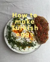 A top-down, well-lit photograph of a homemade Turkish eggs dish served with ezme on toast, set against a neutral, textured background with large yellow text overlay.