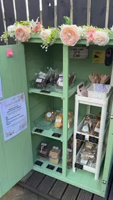 A creator visits a new 'cake shed' in Newcastle, showcasing the variety of homemade treats available for purchase from the small, garden-based shop.
