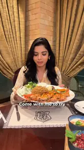 A video review of Samad Al Iraqi restaurant in Kensington, London, featuring a variety of traditional Iraqi dishes including lamb chops, kebabs, grilled shrimp, and kunafa. The creator provides a walkthrough of the dining experience, highlighting the food quality and the restaurant's ambiance.