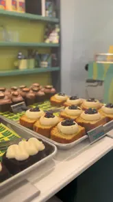 A short video showcasing a selection of loaf cakes and brownies at a bakery called Drizzle, including shots of the display case, the exterior, and the packaged products.