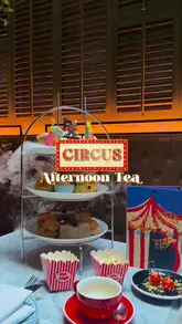 A promotional video showcasing a circus-themed afternoon tea experience. The edit features close-ups of themed sweets, popcorn, and tea service, utilizing dry ice effects to enhance the magical atmosphere.