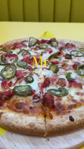 A fast-paced review of Mr T's in Hammersmith, featuring a wide variety of indulgent menu items including butter chicken pizza, loaded fries, toasties, and various desserts. The creator provides a voiceover review of the food, highlighting the new menu items and the overall experience.