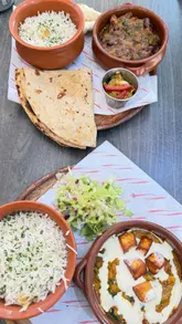 A short, handheld video showcasing the student menu deals at My Karak Chai in Middlesbrough, featuring close-ups of the food and the menu board.