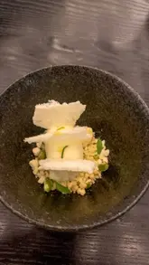 A montage of dishes and scenes from a Michelin-starred Indian restaurant, featuring close-ups of plated food, a bottle of vintage champagne, and the chef in the kitchen.