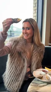 A creator visits Sam's Riverside in Hammersmith, providing a tour of the venue and a review of various dishes including oysters, parmesan fried churros, crab toast, beef tartare, scallops, sea bass, and a crab and gruyere souffle. The video highlights the riverside location and the quality of the modern British cuisine.