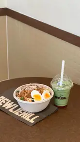A short, straightforward video showcasing a healthy bowl spot called Bewliehill. The video highlights the ordering kiosks, the food preparation process, and the final product, including salads and matcha lattes.
