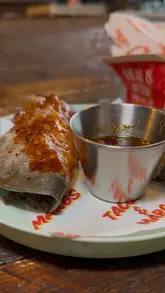 The creator visits Picante in Cains Brewery Village, Liverpool, to review their latest menu offerings. The video features a tour of the venue, close-ups of various tacos (beef birria, coconut shrimp, chicken) and wings, and the creator's enthusiastic taste test reactions.