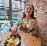 A creator-led listicle post featuring a woman eating tortilla chips and salsa in a restaurant setting, promoting gluten-free dining options in the East Midlands.