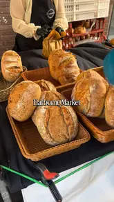 A montage video showcasing various independent food stalls at Harborne Market, including sourdough bread, pizza, pastries, and cakes.