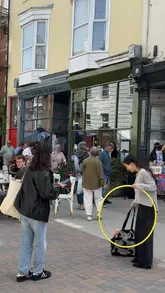 A montage video showcasing a community fete on Castle Road, featuring various local traders, food stalls, live music, and activities like pottery and games.